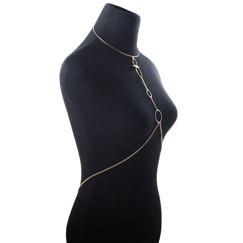 Gold chain necklace on a black mannequin torso against a white background