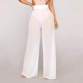 Model wearing Echo & Air women's Sheer Wide Leg Pants in white, showcasing the bohemian high-waisted silhouette and semi-transparent mesh fabric.