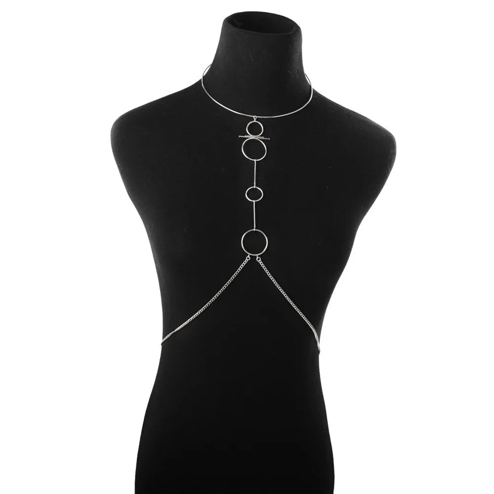 Silver chain body harness on a black mannequin against a white background