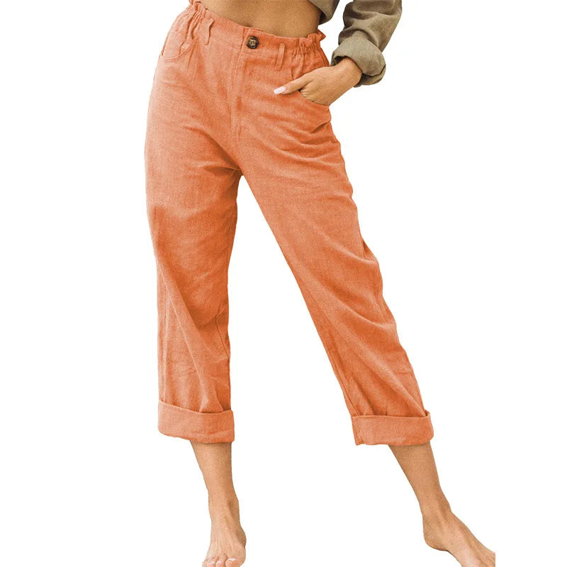 Model wearing Echo & Air women's Linen Cotton Crop Pants in orange showcasing the relaxed tapered harem fit, comfortable side pockets, and rolled cuffs.