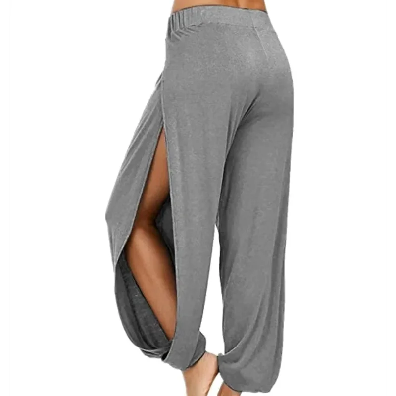 Model from the side wearing Echo & Air women's Ethereal Side-Slit Lounge Pants in gray showcasing the high side leg slit and relaxed harem fit.