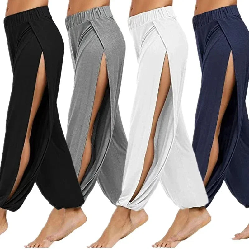 Four models showcasing the Echo & Air Ethereal Side-Slit Lounge Pants in black, gray, white, and navy blue, displaying the high leg slits and relaxed harem silhouette from the side.